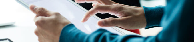 Close-up of hands working on tablet