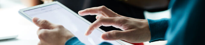 Close-up of hands working on tablet