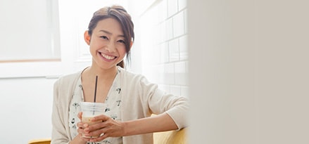 Girl with iced coffee in plastic cup