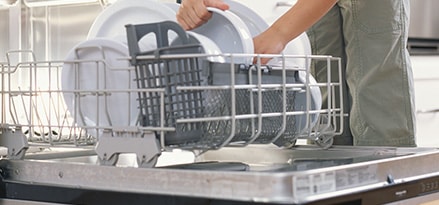 Child loading dishwasher