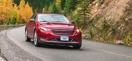 Red Car taking turn on street