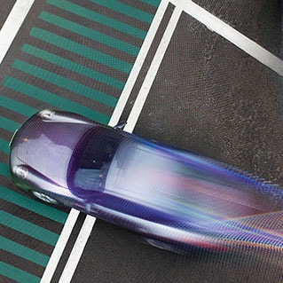 Cars going through intersection with running shutter