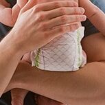 Dad holding baby in diaper