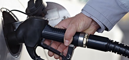 Silver Car being Pumped with gas