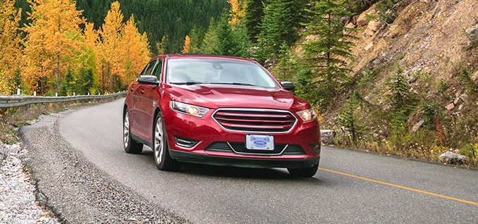 Red Car taking turn on street