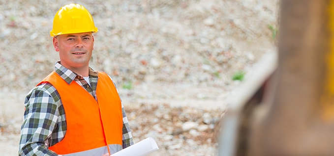 construction worker with hard hat and plans