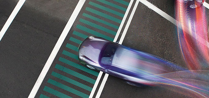 Cars going through intersection with running shutter